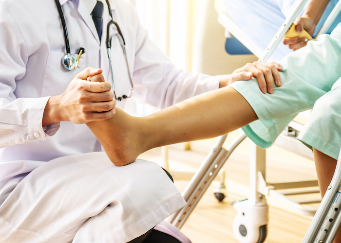 A doctor examining a patient's foot and ankle