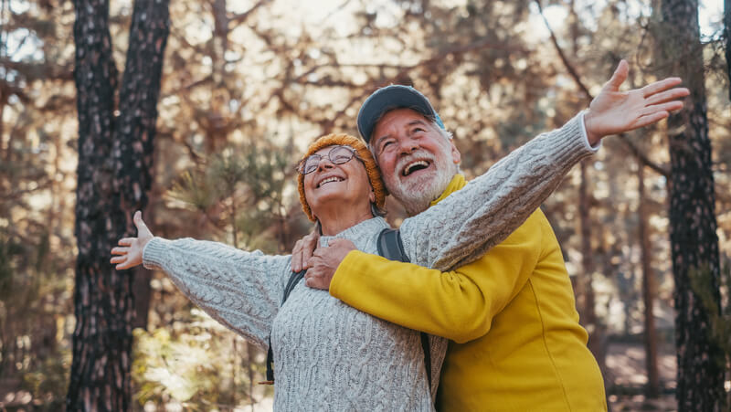 Smiling older couple enjoying the outdoors together.