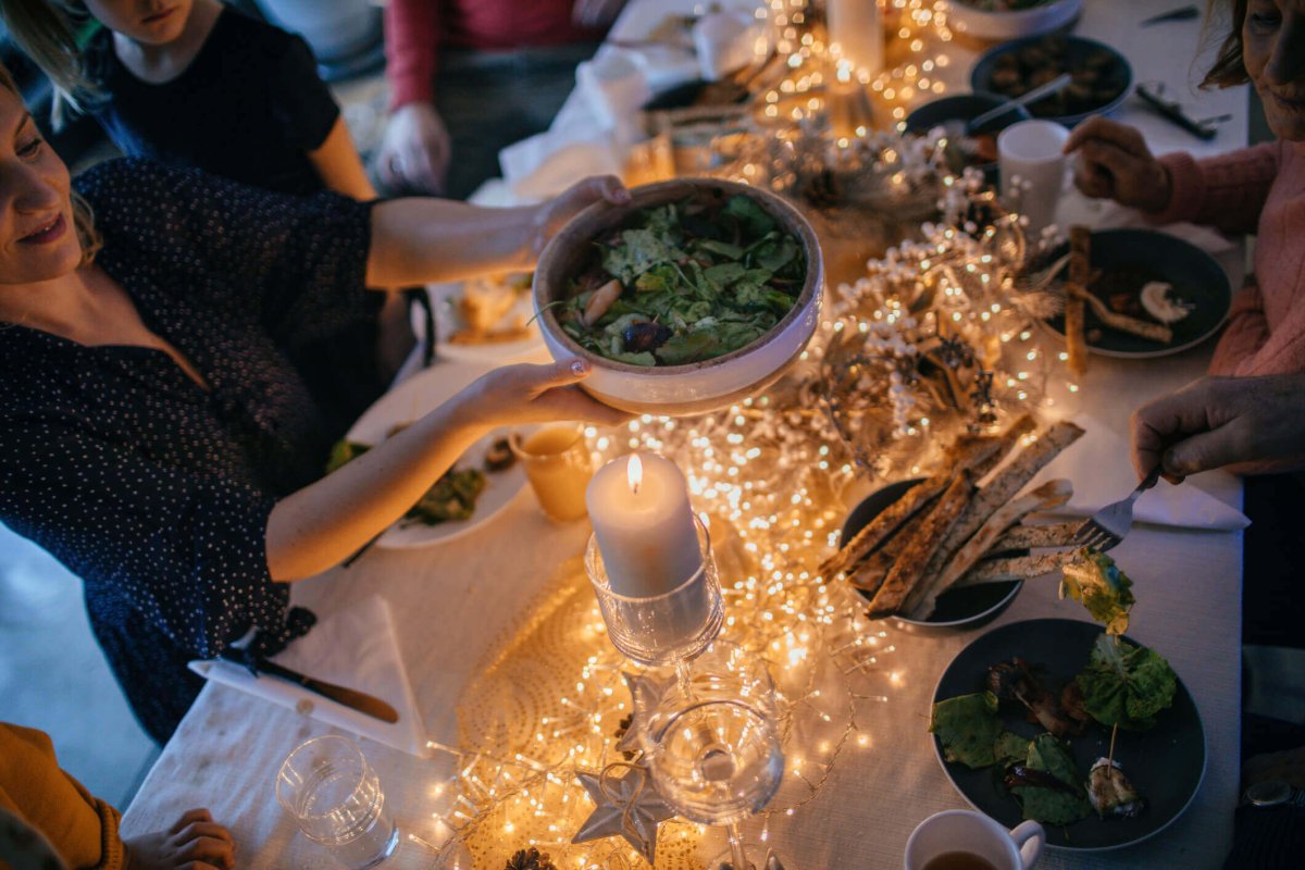 Passing food at holiday gathering